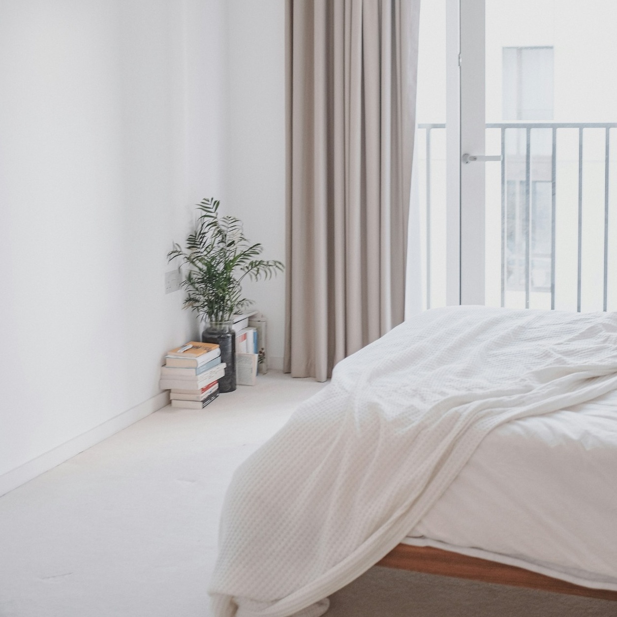 : Modern bedroom featuring soft light carpet professionally installed by Edmonton Flooring Ltd.