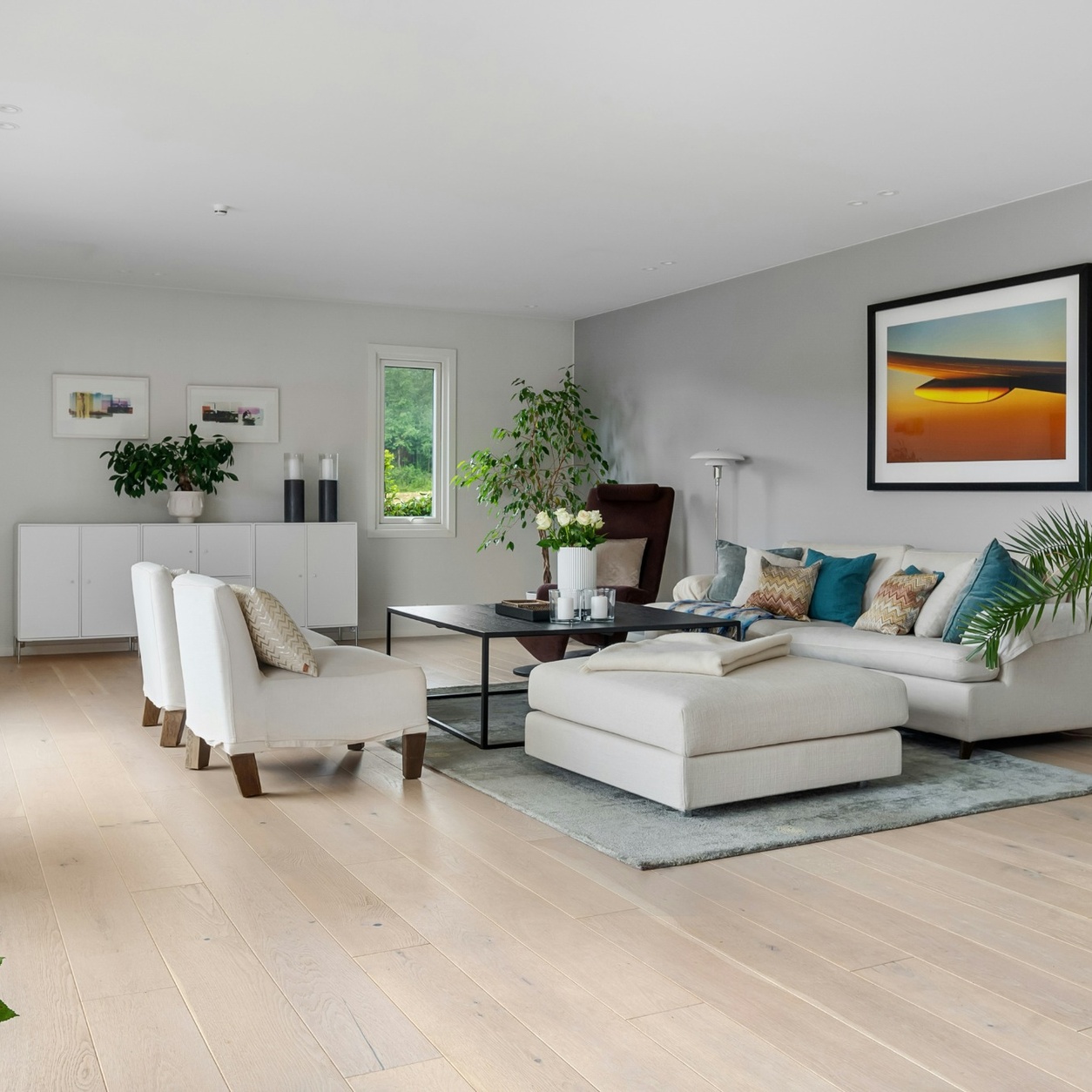Modern living room featuring light oak luxury vinyl plank flooring professionally installed by Edmonton Flooring Ltd.