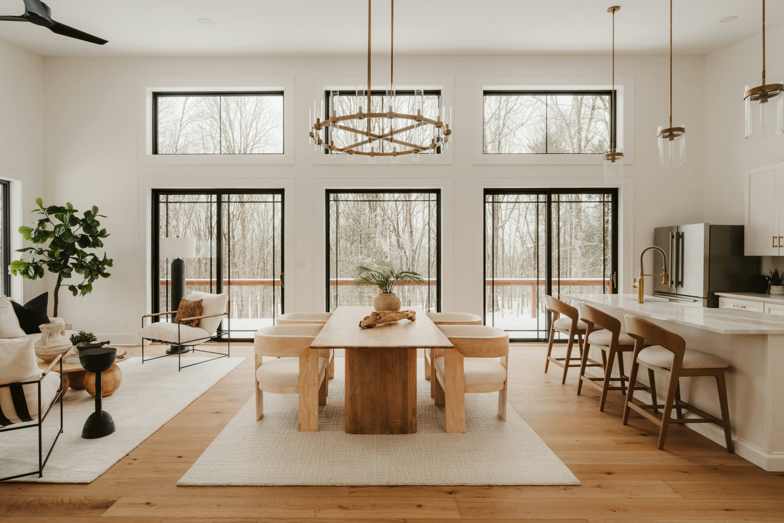 Modern open-concept home with light oak hardwood flooring, dining area, living room, and kitchen by Edmonton Flooring Ltd.