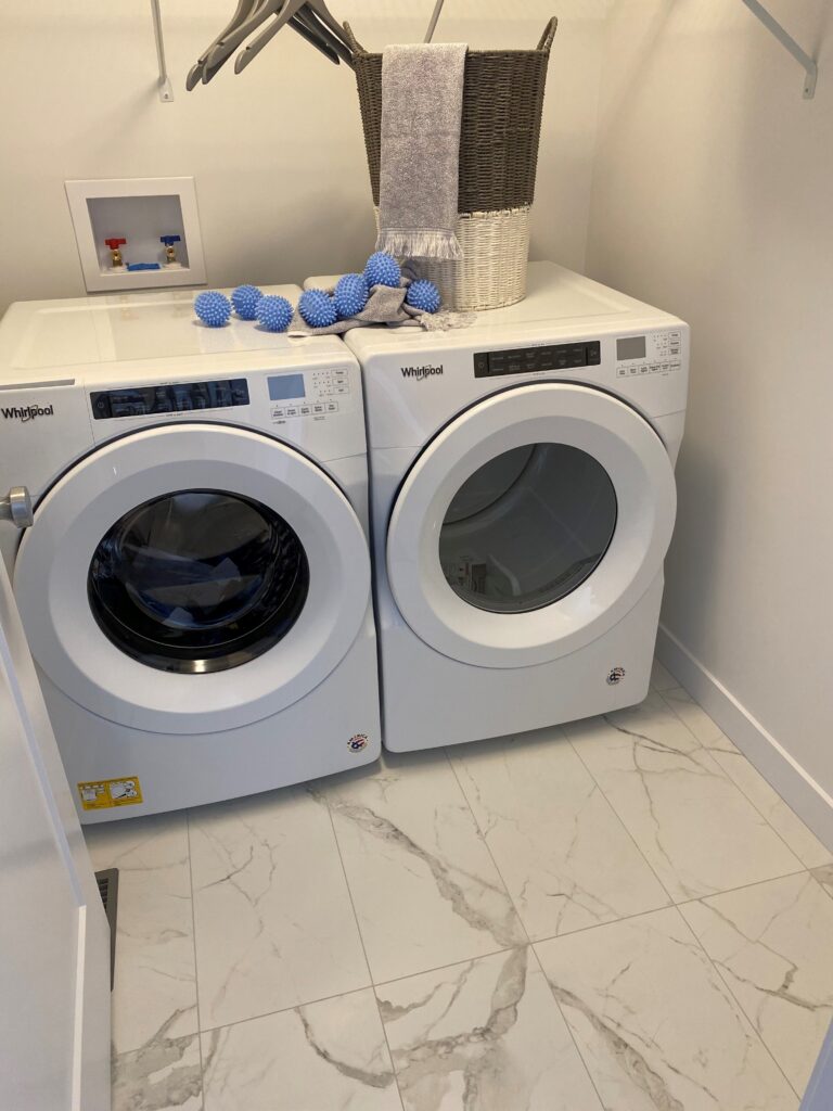 Laundry room renovation with new flooring and modern finishes in Edmonton