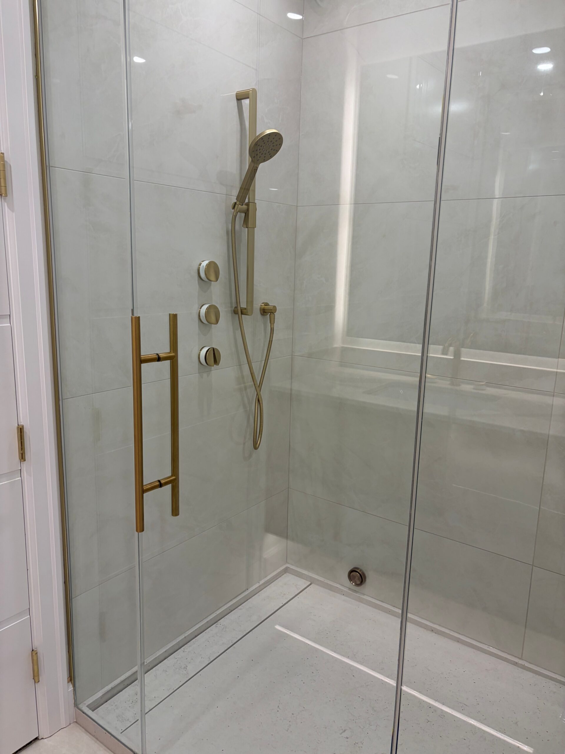 Tiled shower renovation with custom glass enclosure in Edmonton