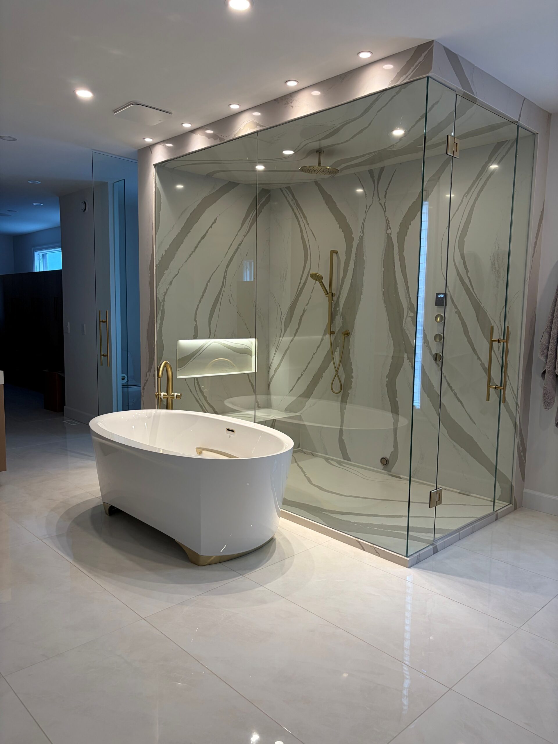 Luxury bathroom renovation with large-format tile shower and freestanding tub in Edmonton